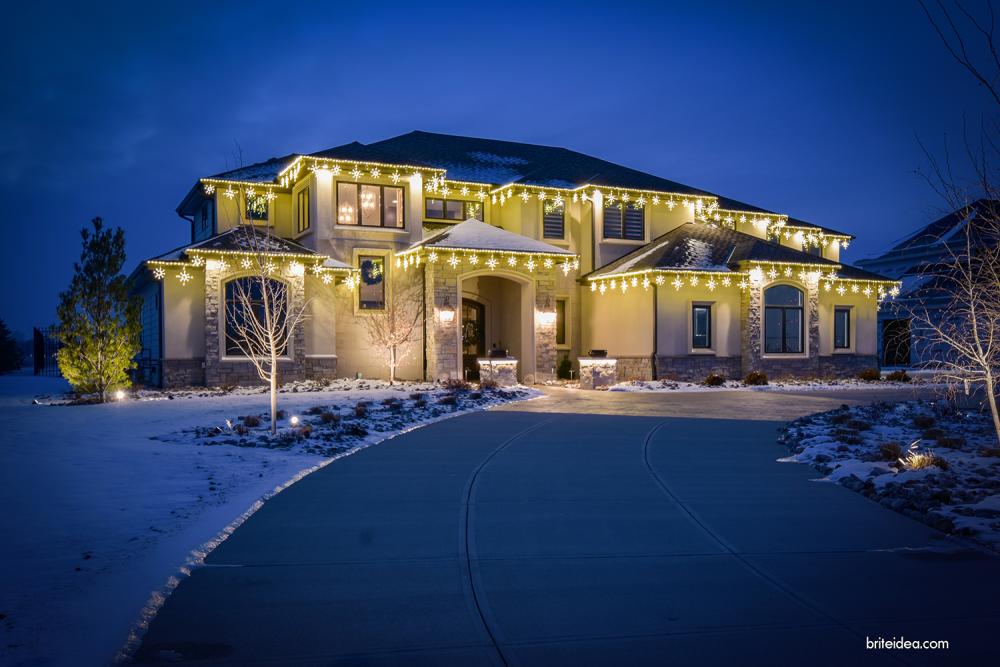 House with white Christmas lights and icicle lights in Papillion, NE