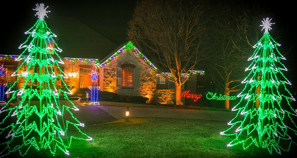 Brite Ideas owner Travis Freeman installing holiday lighting