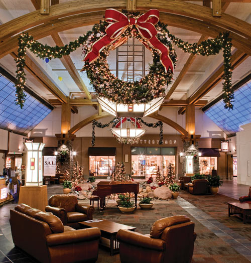 A mall holiday lighting display with wreaths and bows